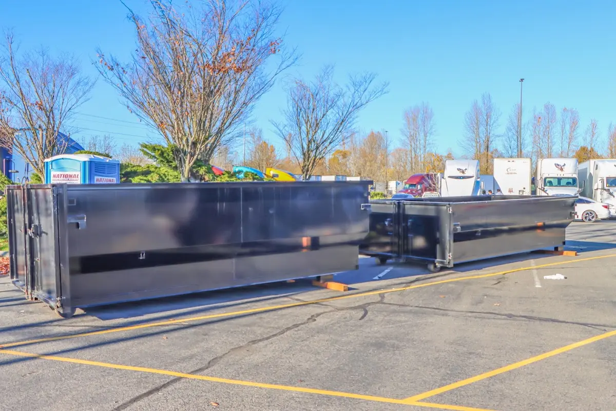 Professional dumpster rental service with roll-off container on residential driveway in Forney